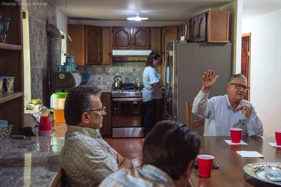 In the kitchen at Rancho El Regalo, Granados tells the ranch’s origin story while his wife, Teresa, makes lunch in the background.